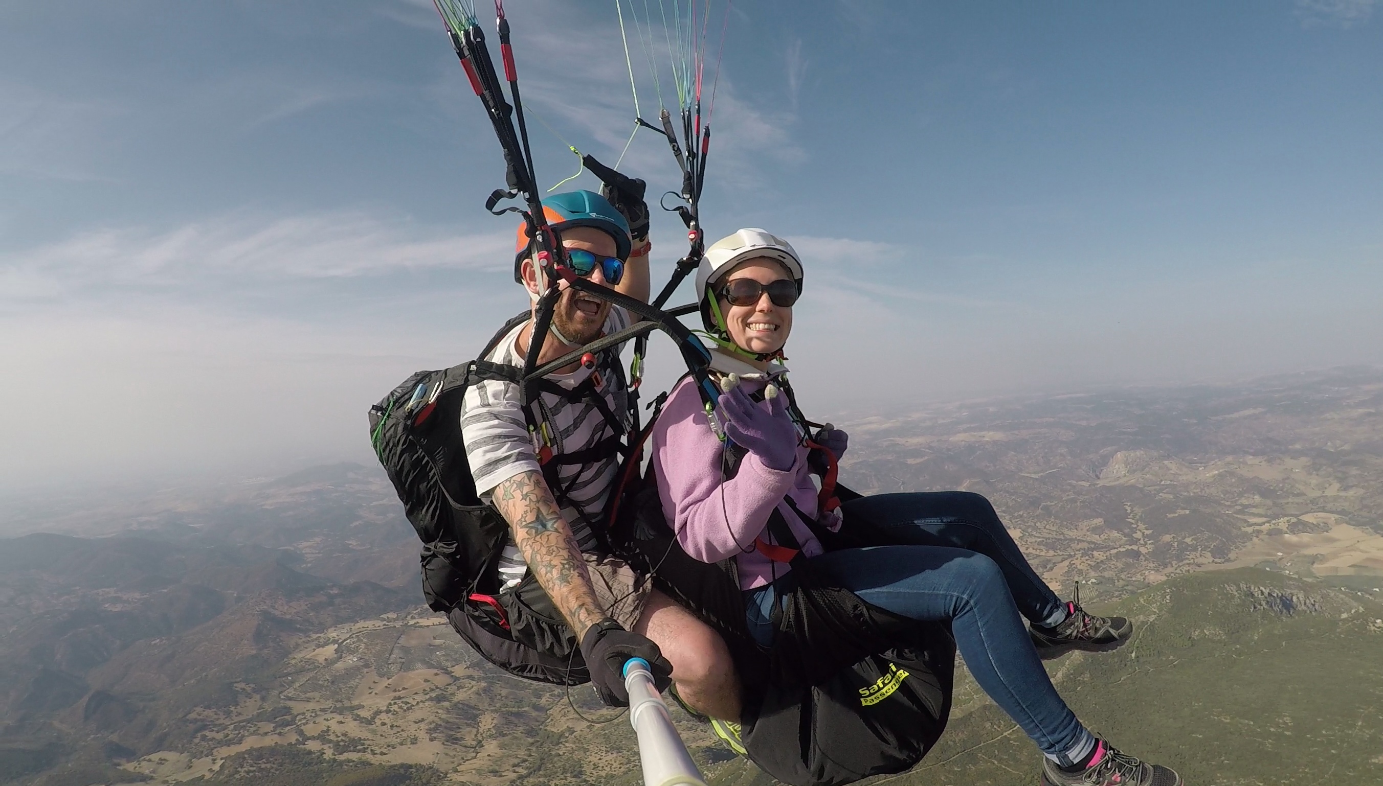 Another happy tandem passenger enjoying her flight with Mile High Paragliding